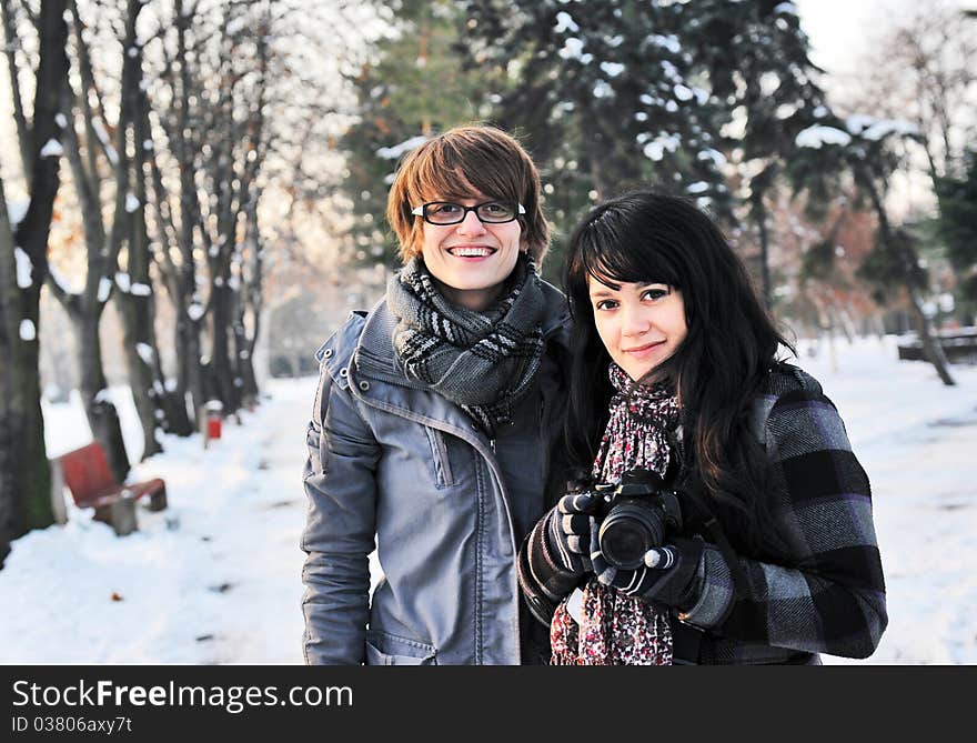 Two girls photographers having fun in the park