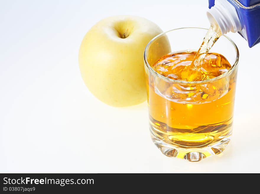 Yellow apple and glass filling with apple juice. Yellow apple and glass filling with apple juice