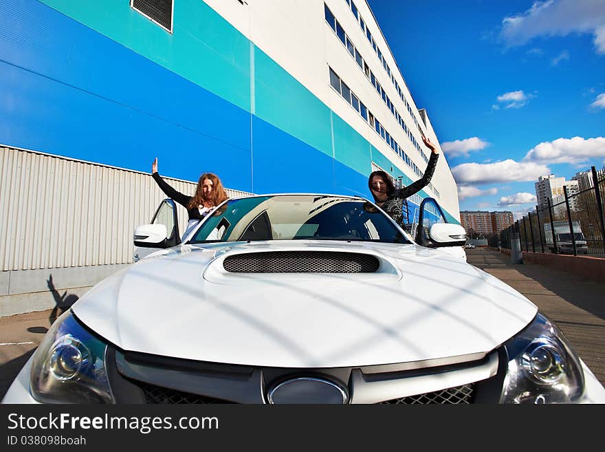 Two beautiful girls friend in white sports car