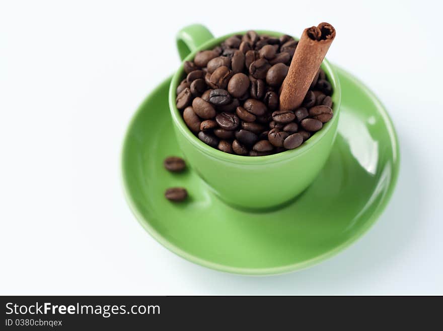 Coffee beans in a green cup