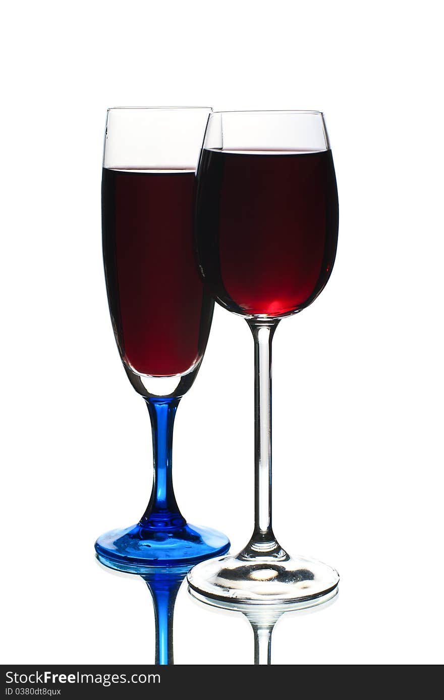 Two wineglasses filled with red wine.