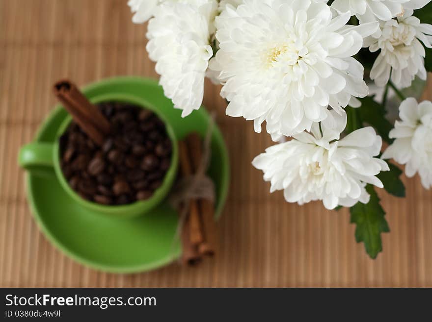 Coffee beans in a green cup