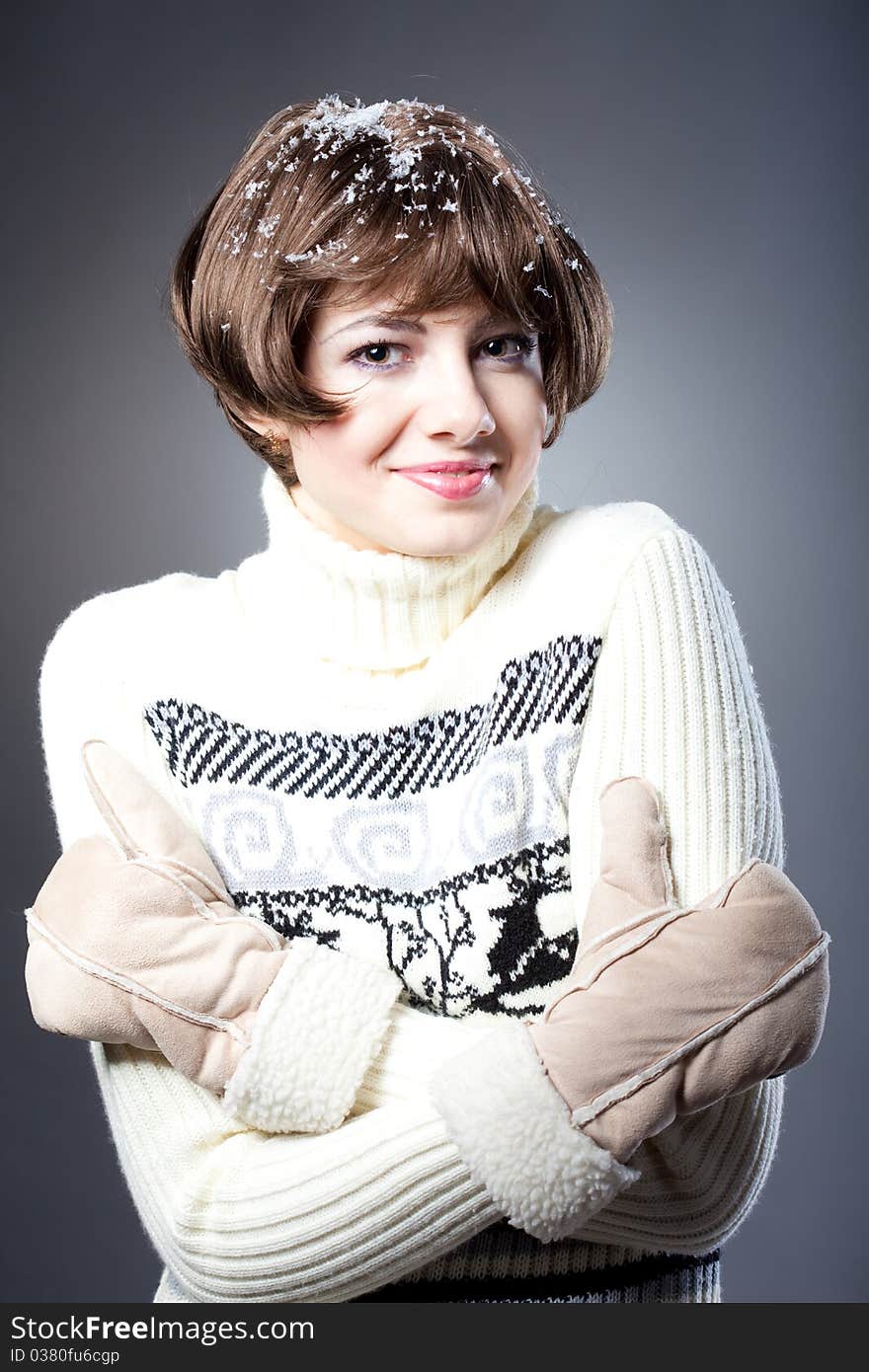 Young beautiful girl rejoices to snow, On a dark blue background