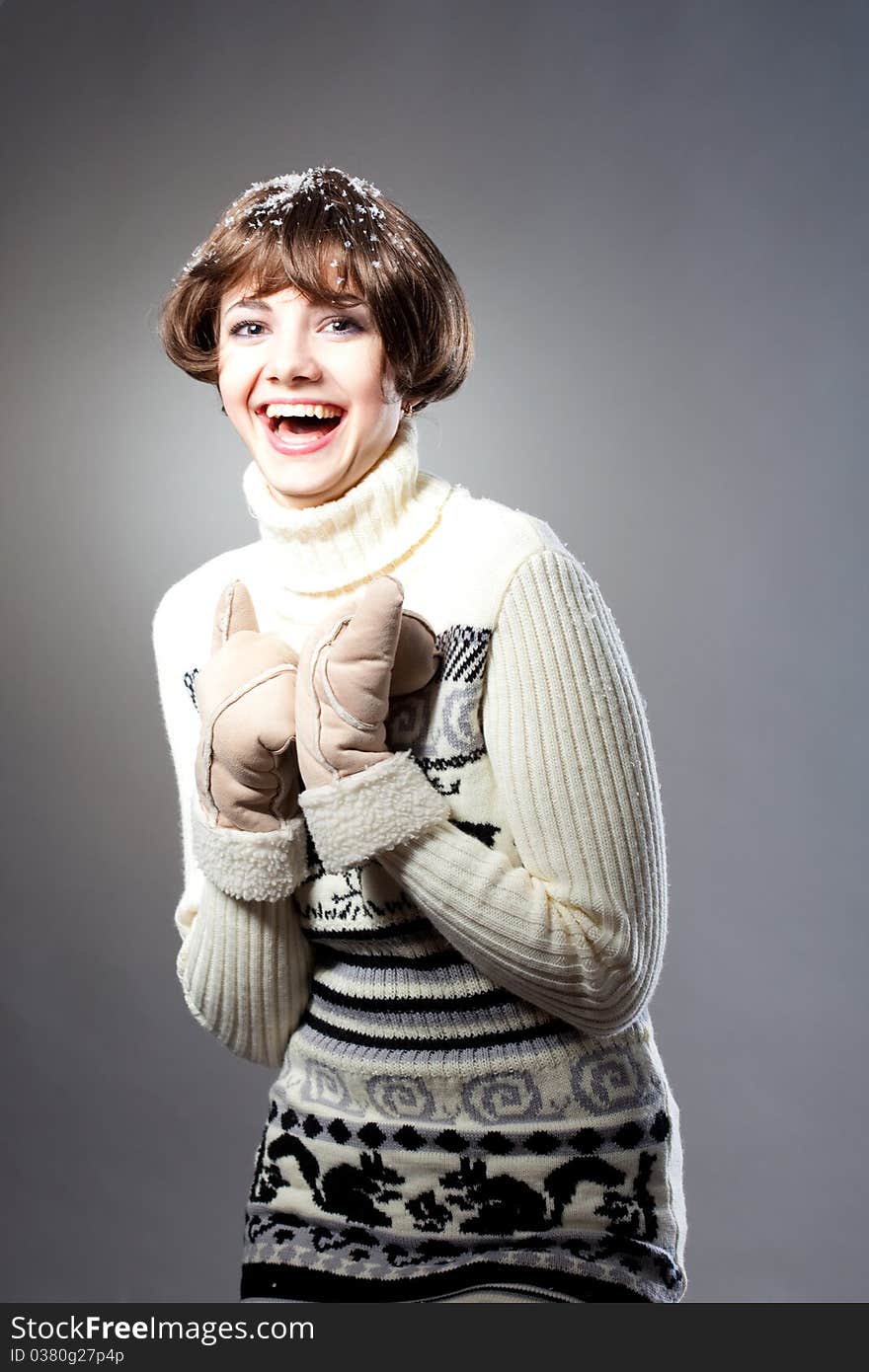 Young beautiful girl rejoices to snow, On a dark blue background