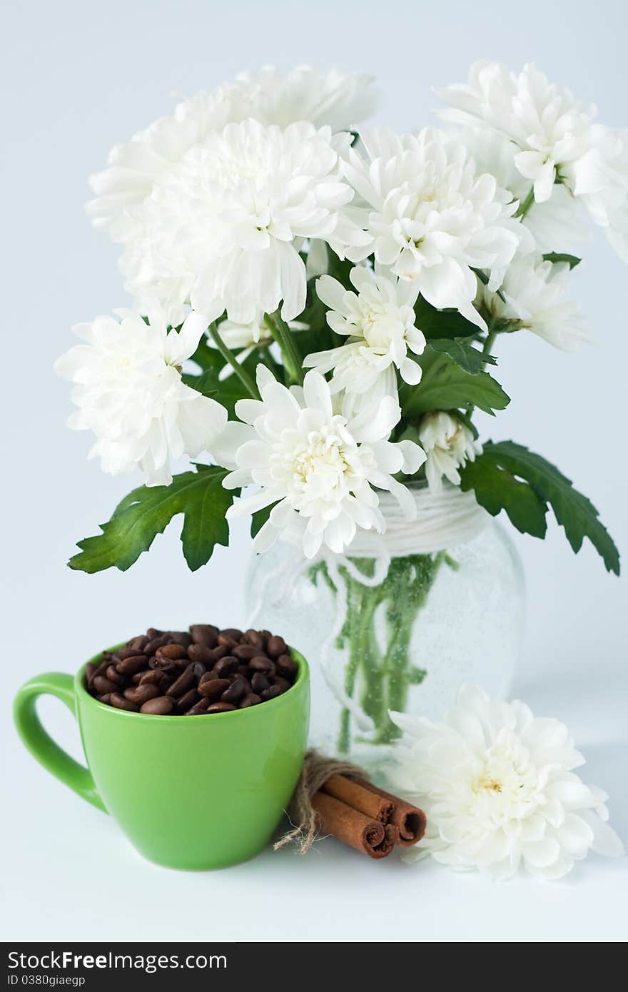 Coffee Beans And Cinnamon Stick In A Green Cup