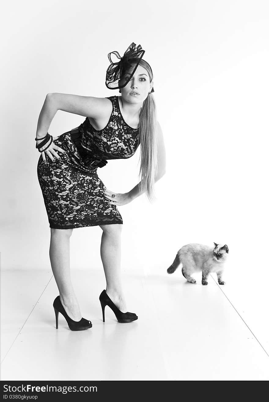 Young beautiful woman with cat, retro, vintage, standing blond girl, studio glamour portrait, black and white photo, b&w. Young beautiful woman with cat, retro, vintage, standing blond girl, studio glamour portrait, black and white photo, b&w