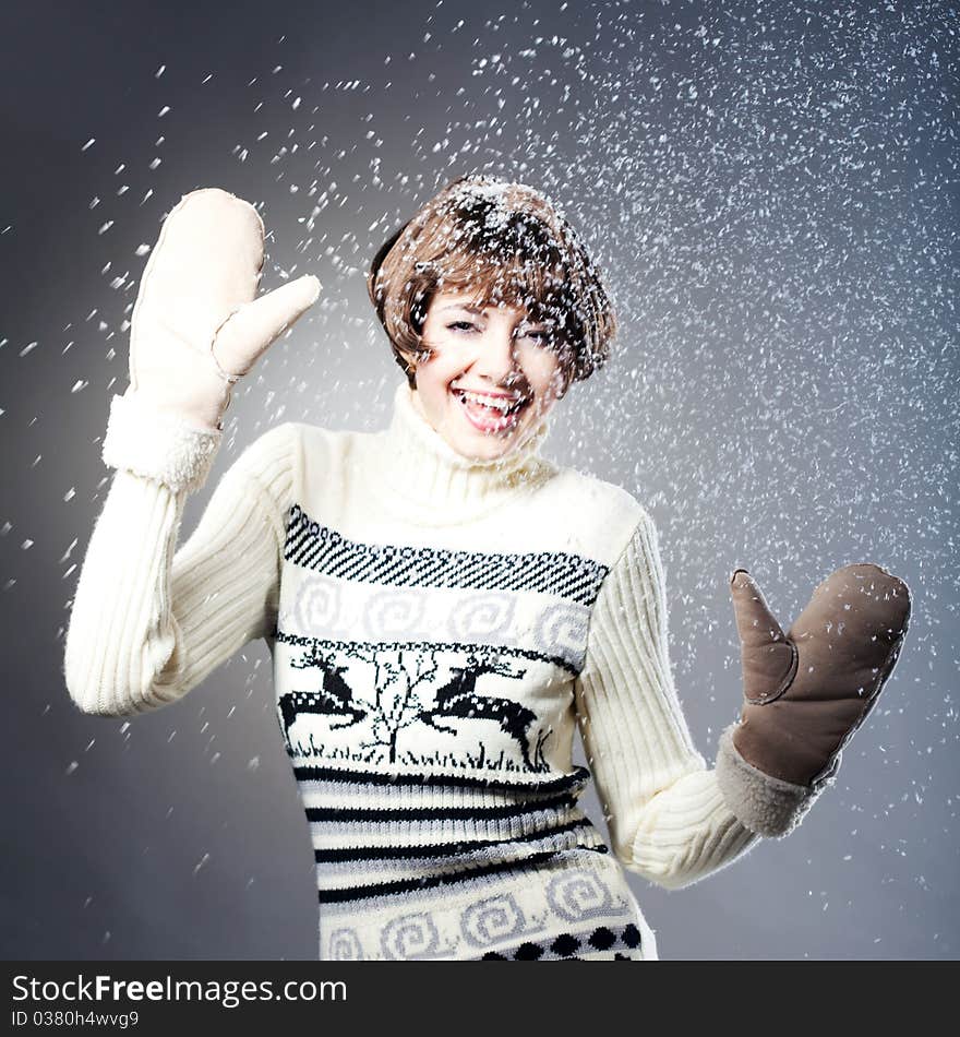 Young beautiful girl rejoices to snow