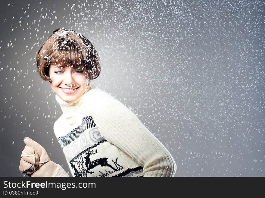 Young beautiful girl rejoices to snow, On a dark blue background