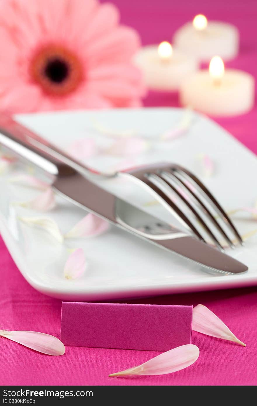 Place setting with candle, flower and tag. Place setting with candle, flower and tag