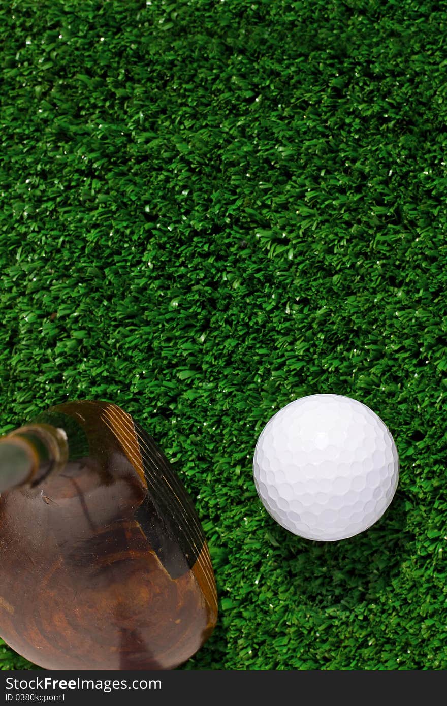 Golf Ball and driver on green grass