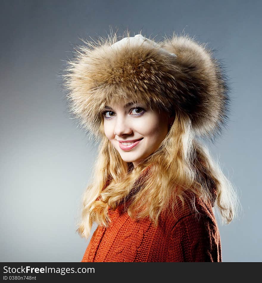 Young beautiful girl rejoices to snow, On a dark blue background