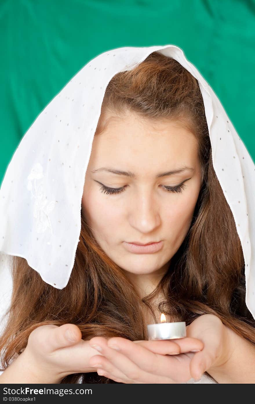 Girl with a covering her head and a candle in his hand. Girl with a covering her head and a candle in his hand