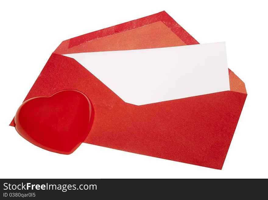 Red heart laying next to a red envelope with white paper on a white background. Red heart laying next to a red envelope with white paper on a white background.