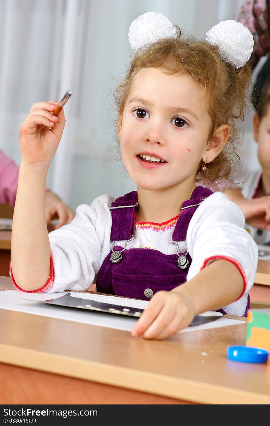 Preschooler girl 4 years old drawing in classroom