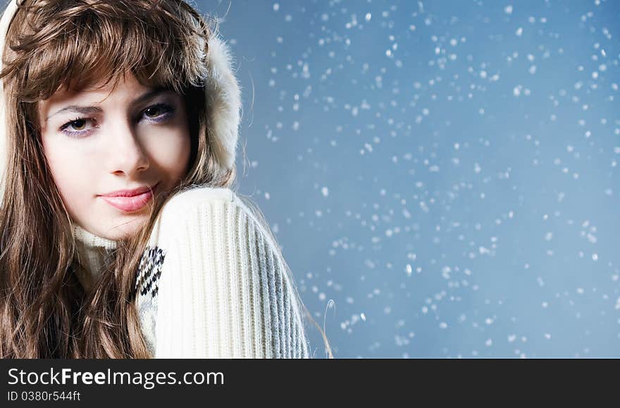 Young beautiful girl rejoices to snow, On a dark blue background