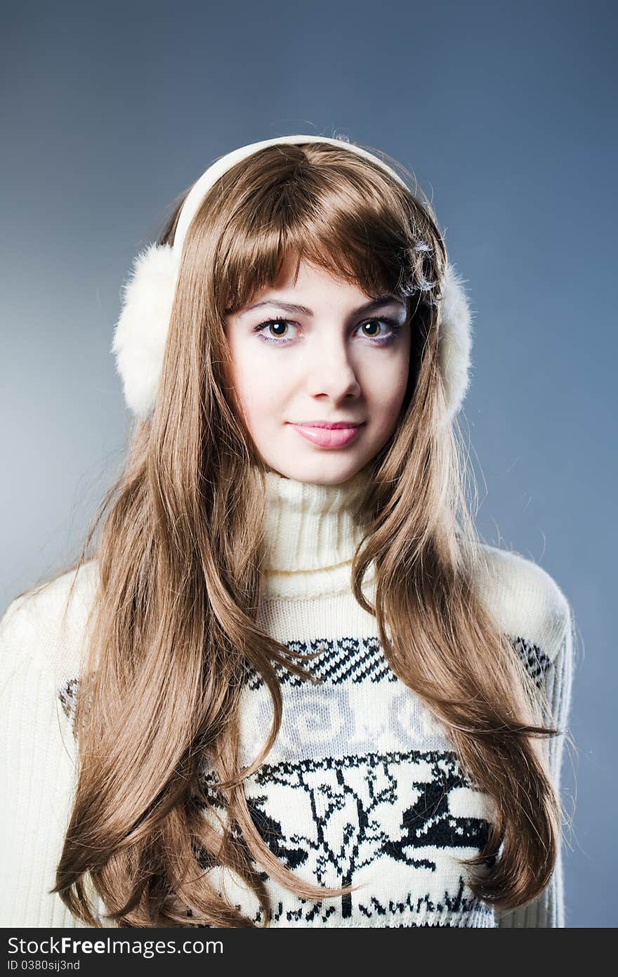 Young beautiful girl rejoices to snow, On a dark blue background