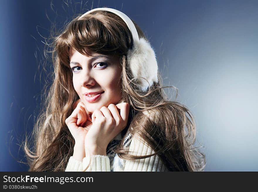 Young beautiful girl rejoices to snow, On a dark blue background