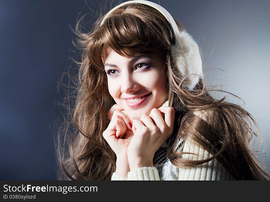 Young beautiful girl rejoices to snow, On a dark blue background