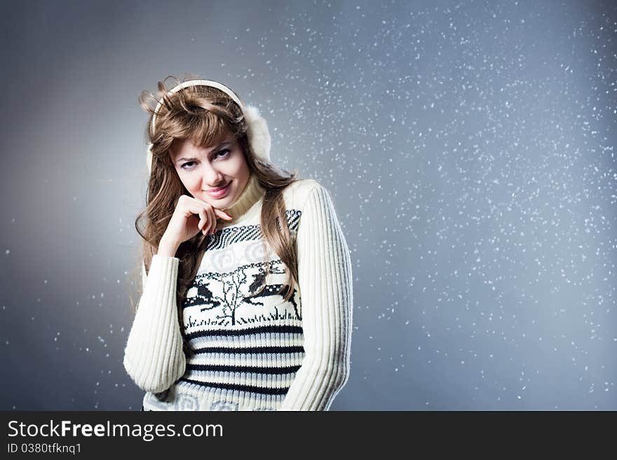 Young beautiful girl rejoices to snow, On a dark blue background