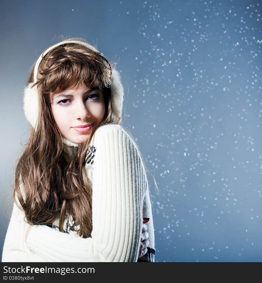 Young beautiful girl rejoices to snow, On a dark blue background