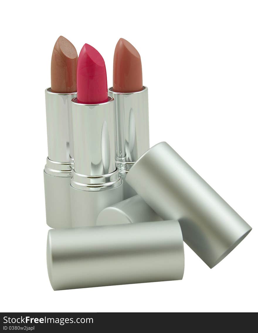 Three lipsticks over white background