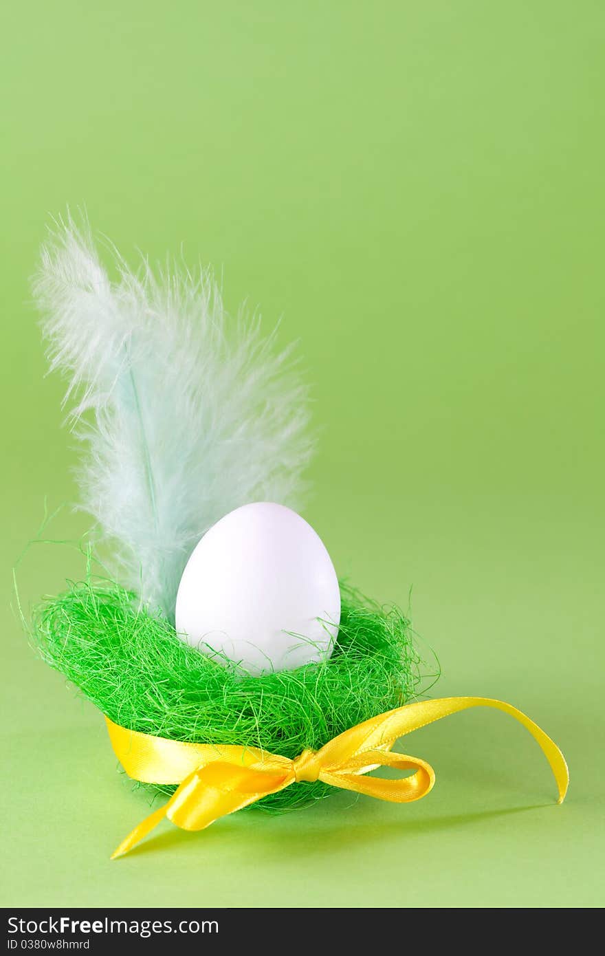 Easter egg in basket with ribbon and copy space. Easter egg in basket with ribbon and copy space