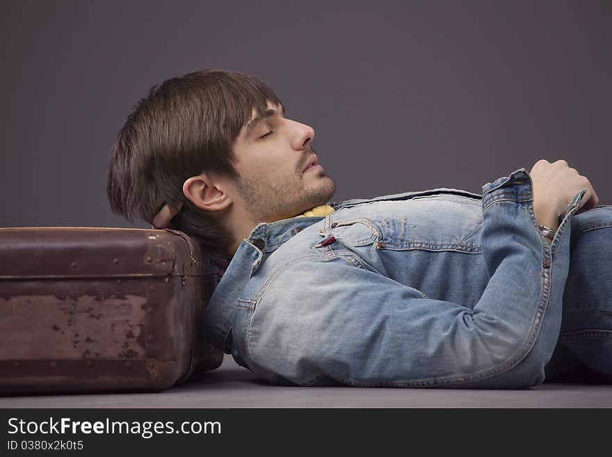 Man relaxing on suitcase