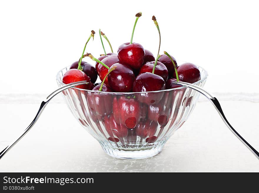 A bowl of fresh cherry with two fruit fork for couple. A bowl of fresh cherry with two fruit fork for couple.