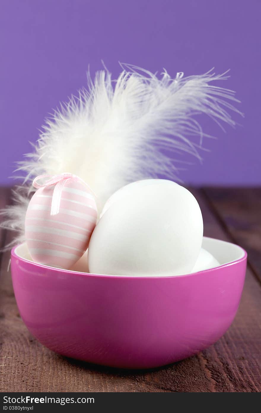 Easter eggs in a bowl with feather