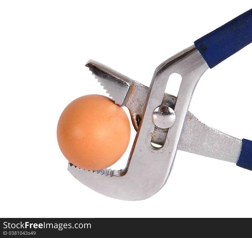 Egg clamped in a vise pipe fittings key on a white background