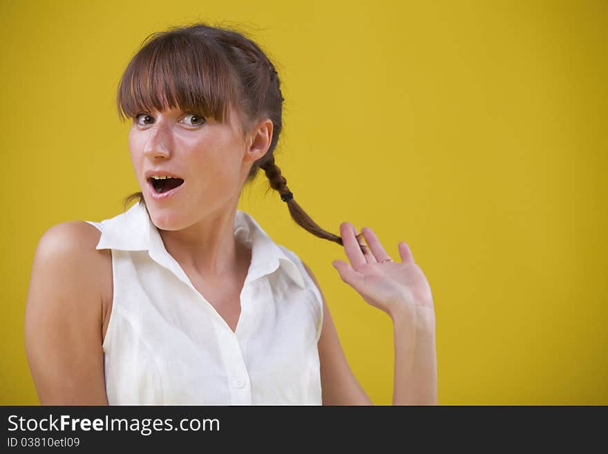 Innocent woman with face expression over yellow background