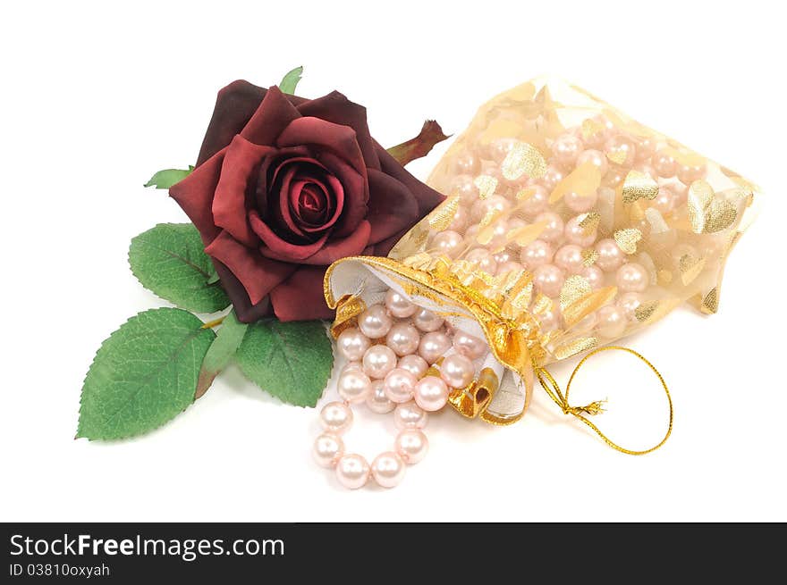 Pearl necklace and roses on a white background. Pearl necklace and roses on a white background