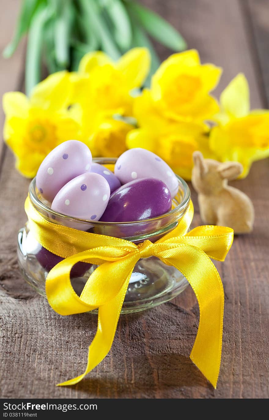 Easter eggs in a bowl with ribbon and daffodils. Easter eggs in a bowl with ribbon and daffodils