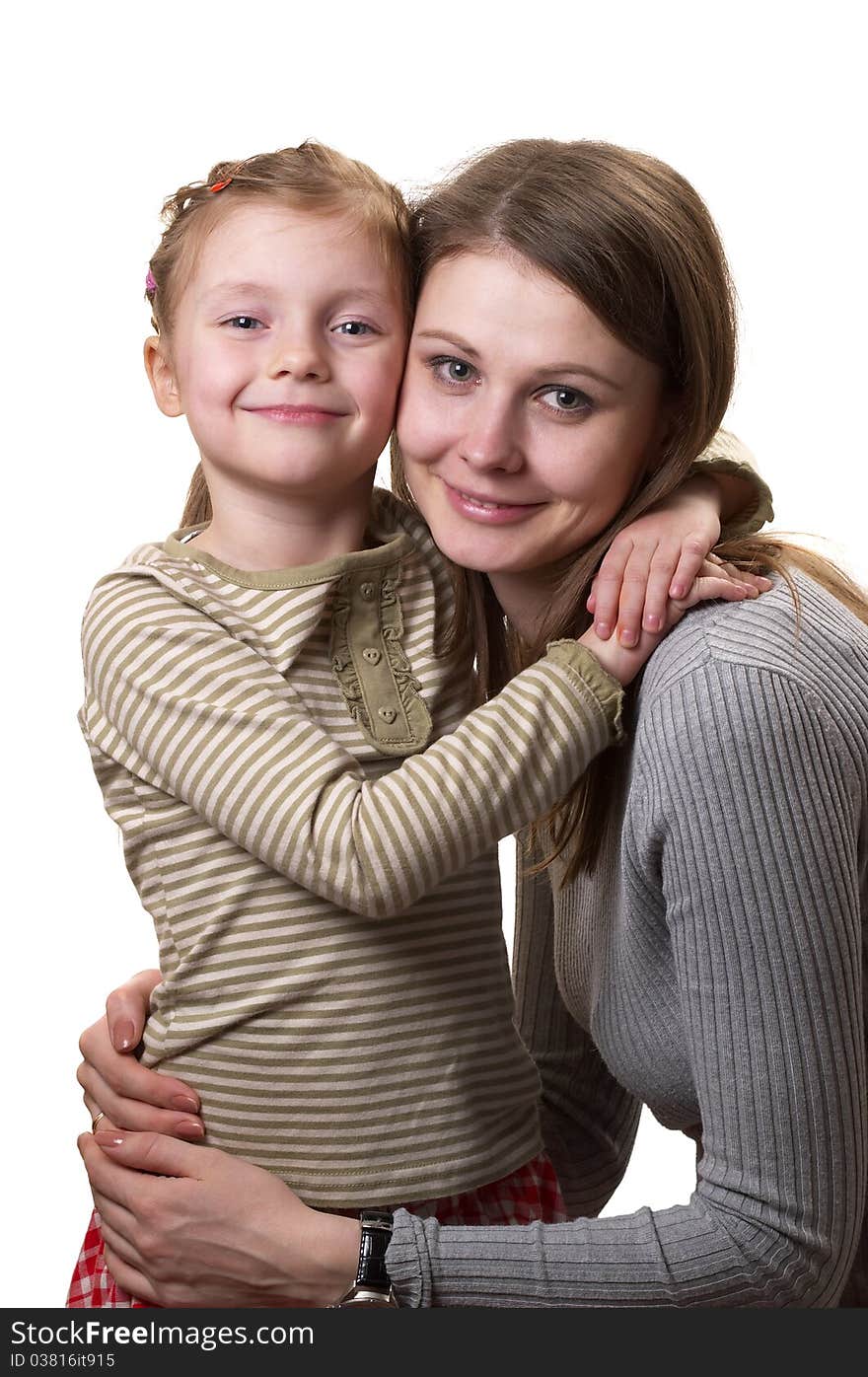 Mother and her little daughter hugging each other isolated over white background. Mother and her little daughter hugging each other isolated over white background