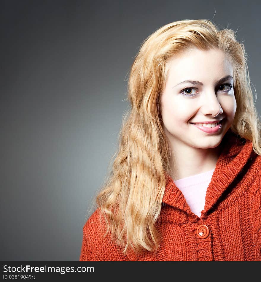 Young beautiful girl in a warm orange jacket