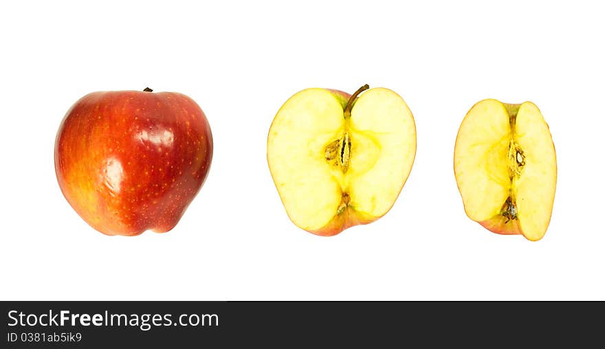 A whole apple, half and quartered apples isolated on a white background. A whole apple, half and quartered apples isolated on a white background.