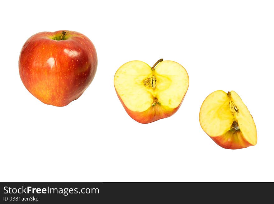 A whole apple, half and quartered apples isolated on a white background. A whole apple, half and quartered apples isolated on a white background.