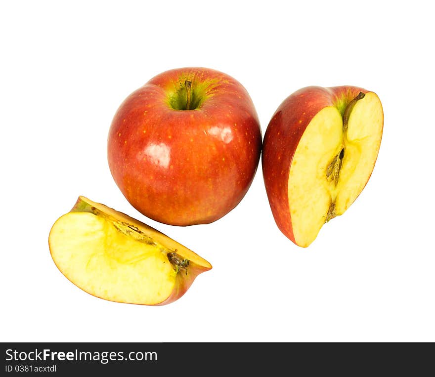 A whole apple, half and quartered apples isolated on a white background. A whole apple, half and quartered apples isolated on a white background.