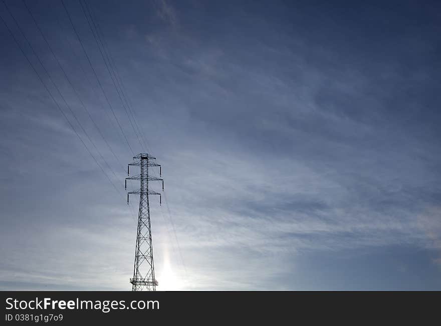 Power lines against blue sky