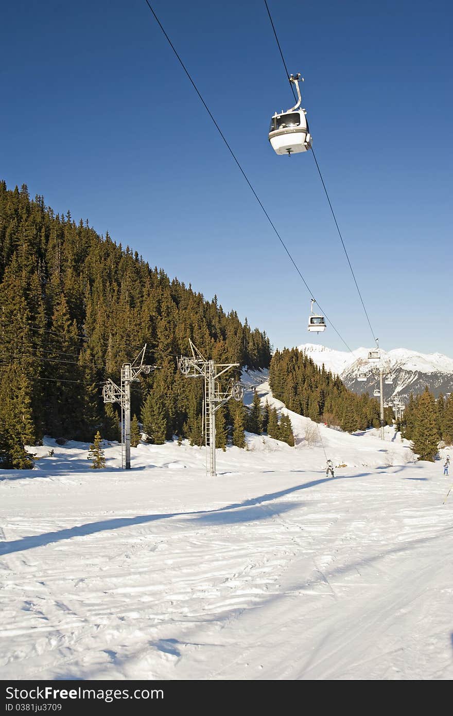 Cable car lift over a ski slope through the trees. Cable car lift over a ski slope through the trees