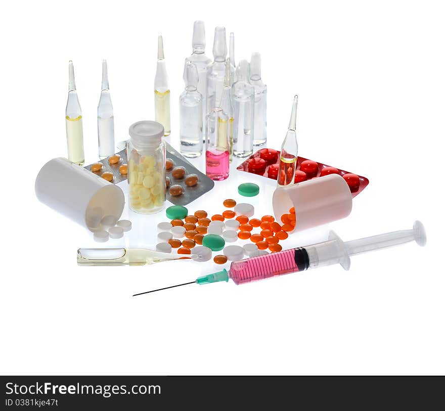 A lot of colorful pills and ampoules on white background. A lot of colorful pills and ampoules on white background