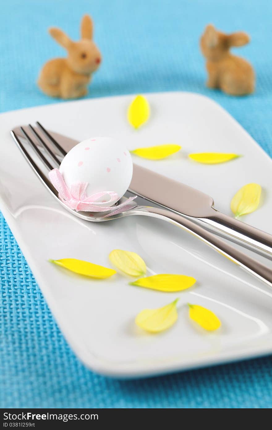 Blue place setting with petals and bunnies. Blue place setting with petals and bunnies