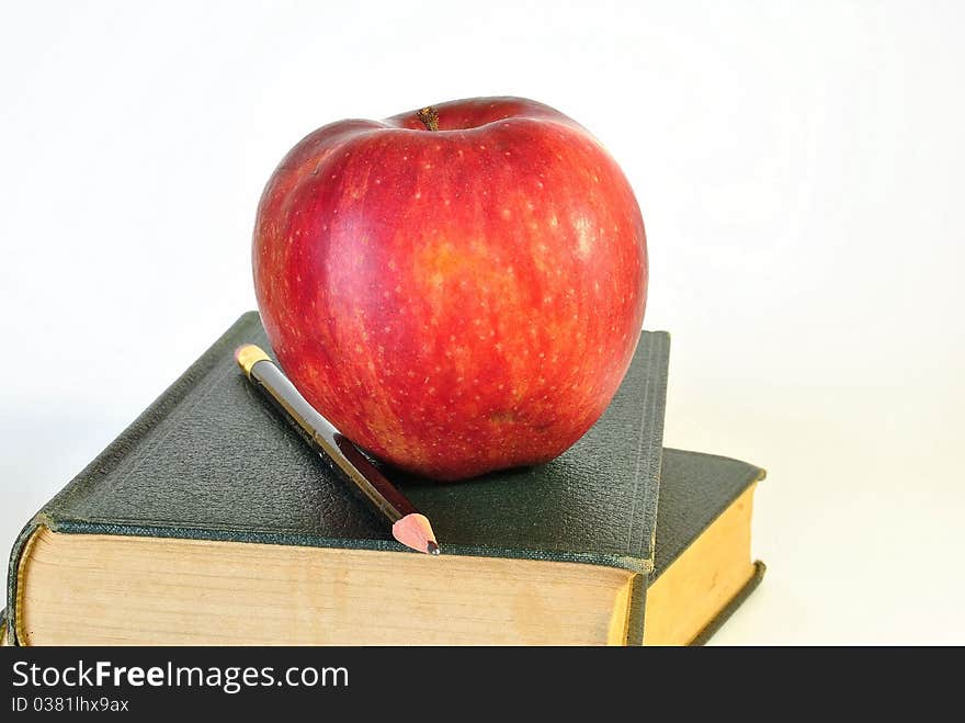 Two old books with a ripe,red apple. Two old books with a ripe,red apple