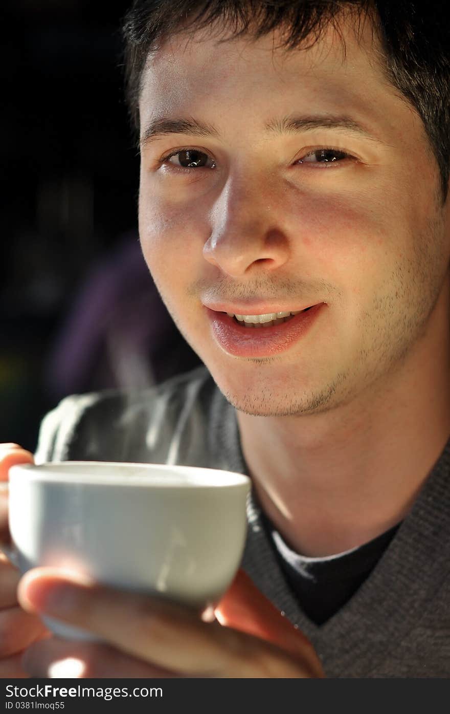 Young man enjoying cup of coffee. Young man enjoying cup of coffee