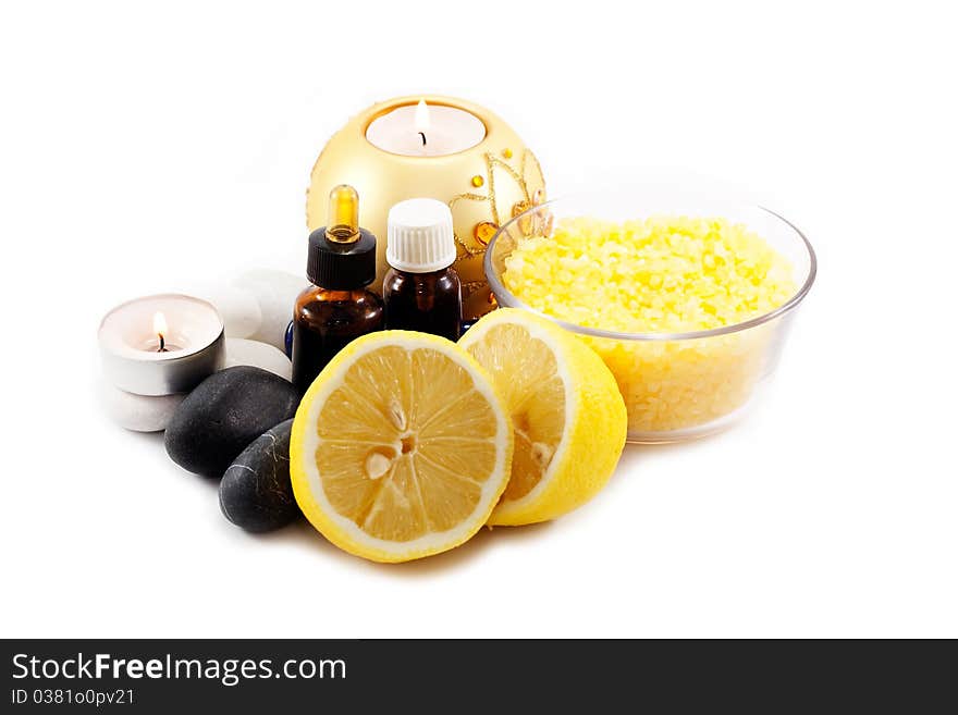 Candles, lemon and sea salt with stones isolated on white background. Candles, lemon and sea salt with stones isolated on white background