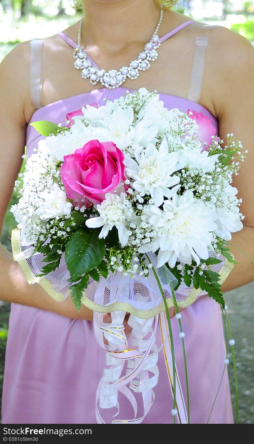 Beautiful white wedding bouquet in hands of the bride.