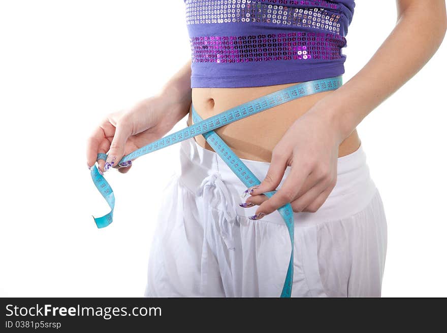 The young girl measures waist volume. The young girl measures waist volume