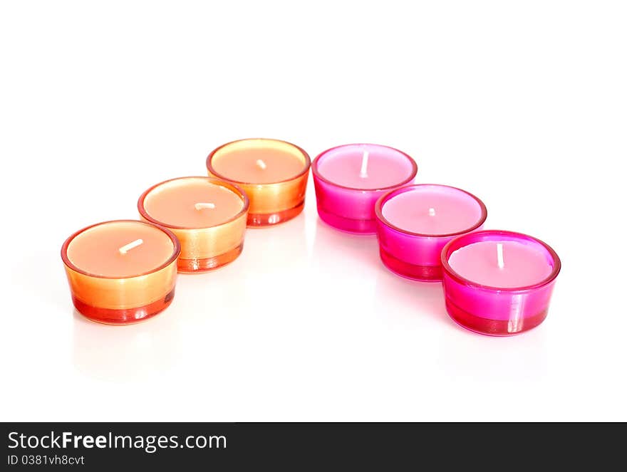 Pink and orange candles in glass isolated on white. Pink and orange candles in glass isolated on white.