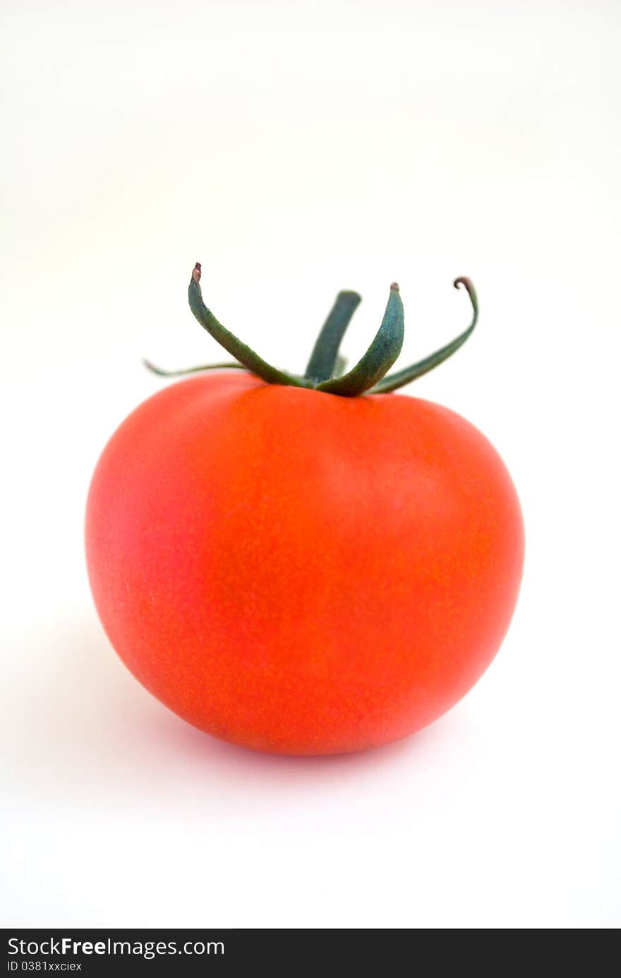 Ripe red tomato at the white background