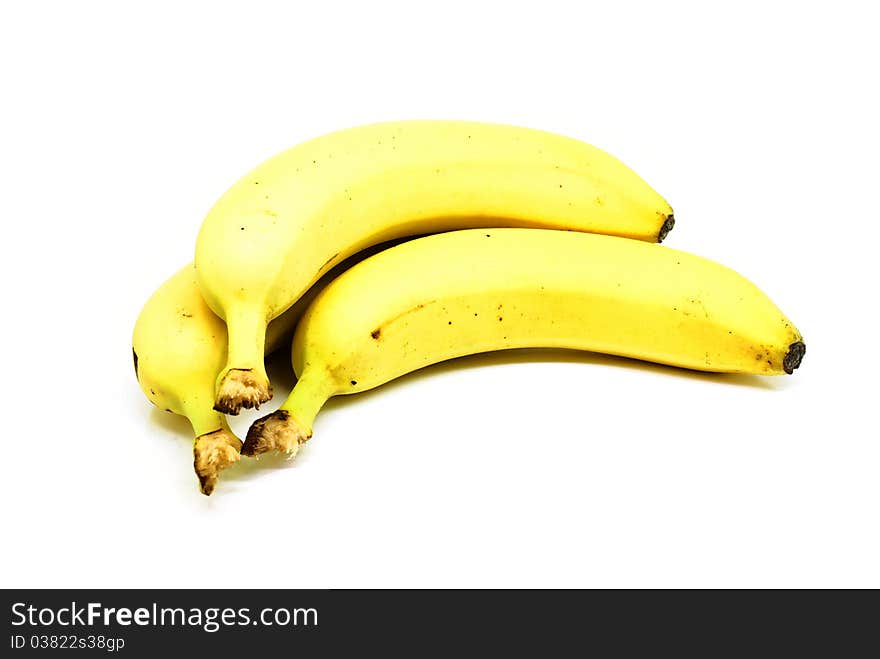 Three ripe bananas isolated on white background.